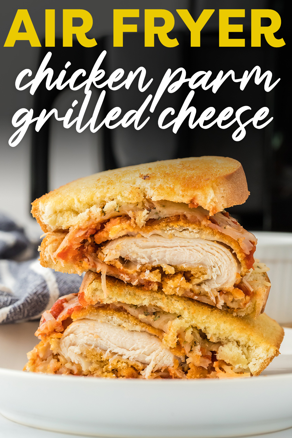 Chicken Parmesan sandwich cut in half and stacked on top of itself.