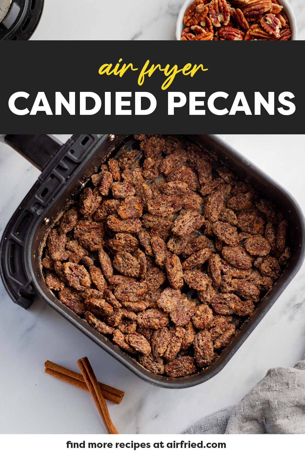 Candied pecans in an air fryer basket.