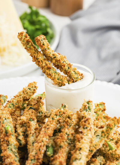 Two green bean fries dipped in Ranch dressing.