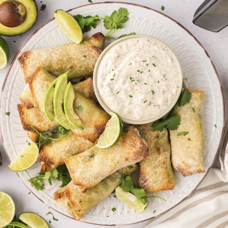 Avocado egg rolls on a plate with Ranch.