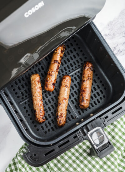 Chicken sausage in air fryer basket.