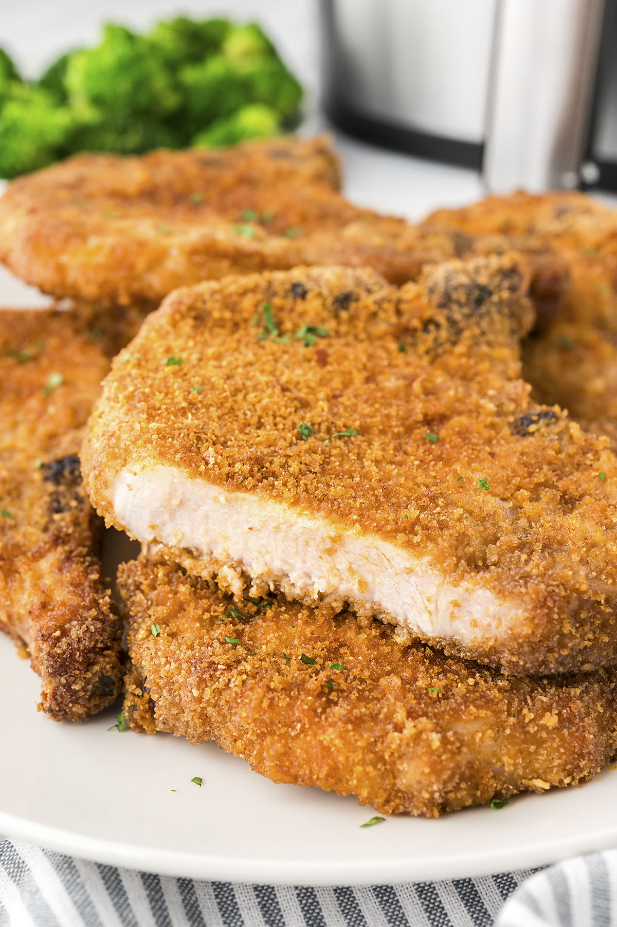 Breaded pork chops on plate.