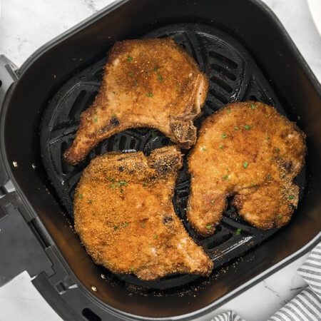 Shake and bake pork chops in air fryer basket.