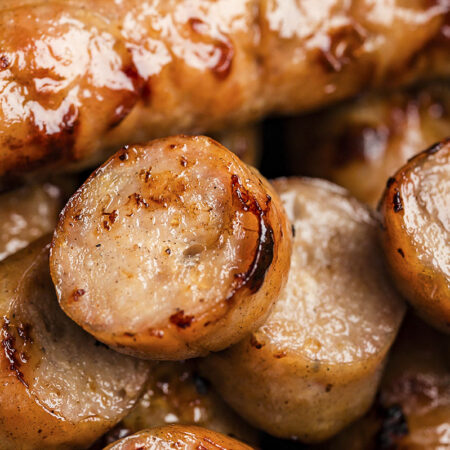 Slices of chicken sausage in air fryer.