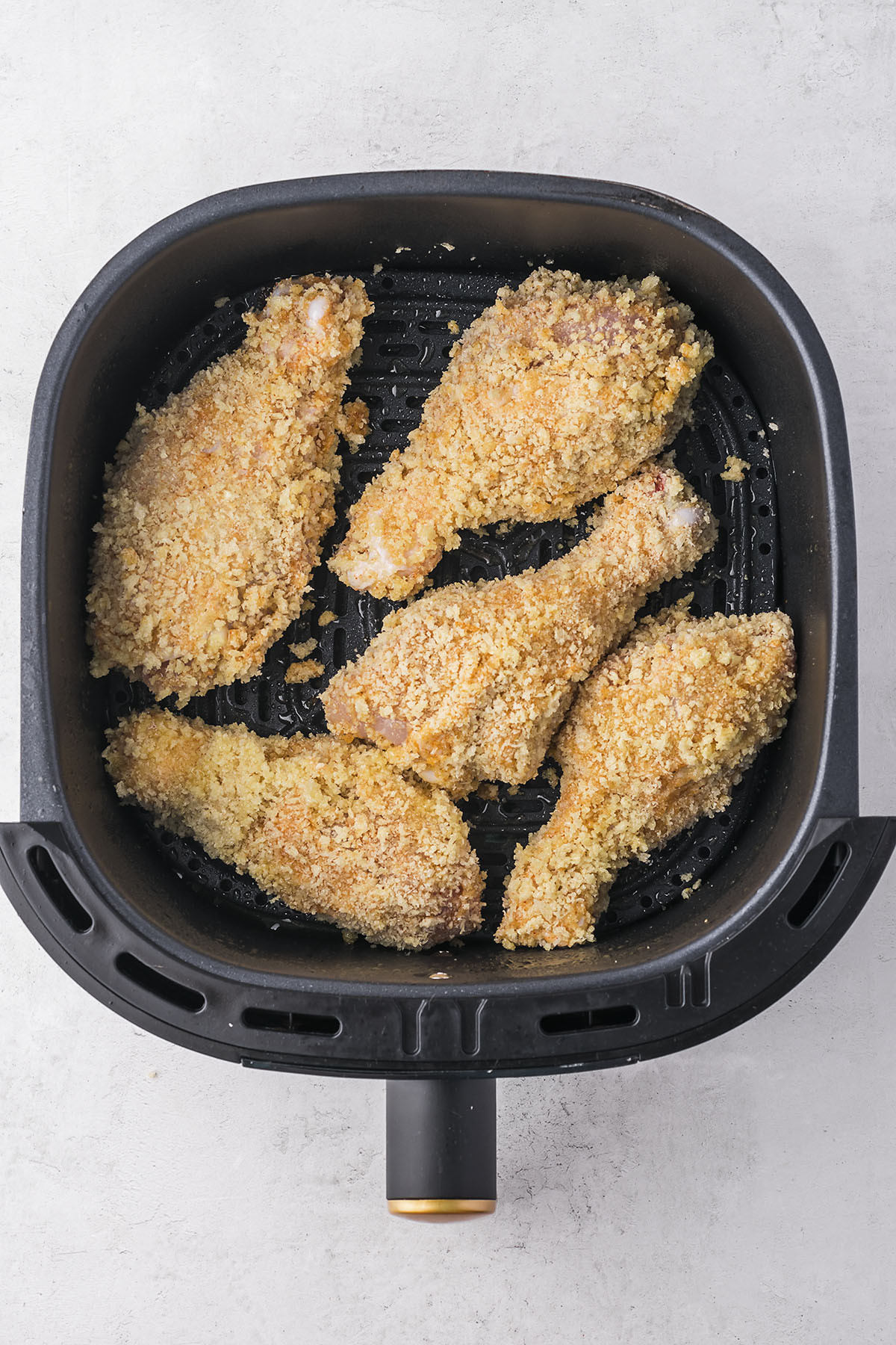 Breaded drumsticks in air fryer.