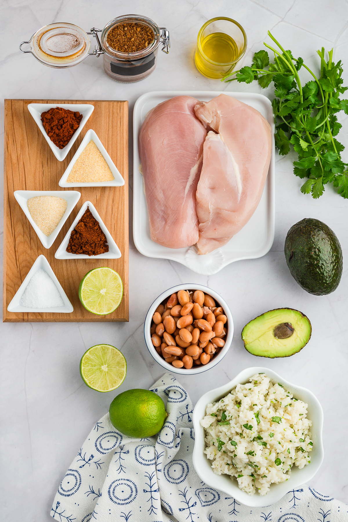 Chicken burrito bowl ingredients spread out on a countertop.