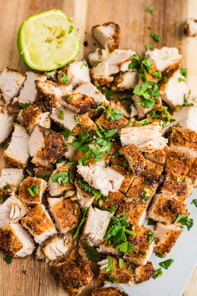 Cooked chicken breast cut into small squares.