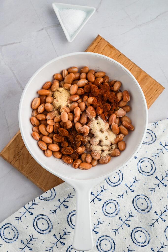 Beans and seasonings in a white bowl.