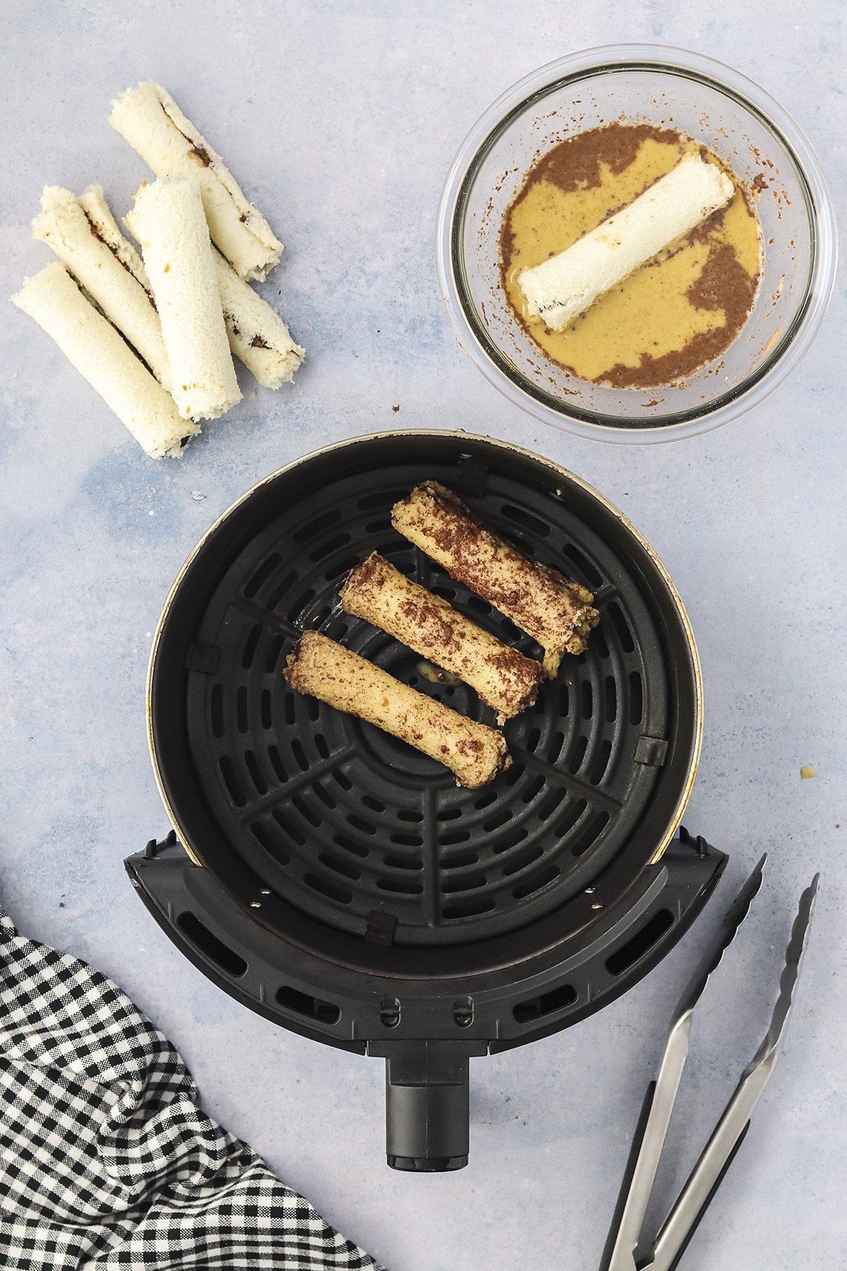 French toast roll ups in air fryer before cooking.