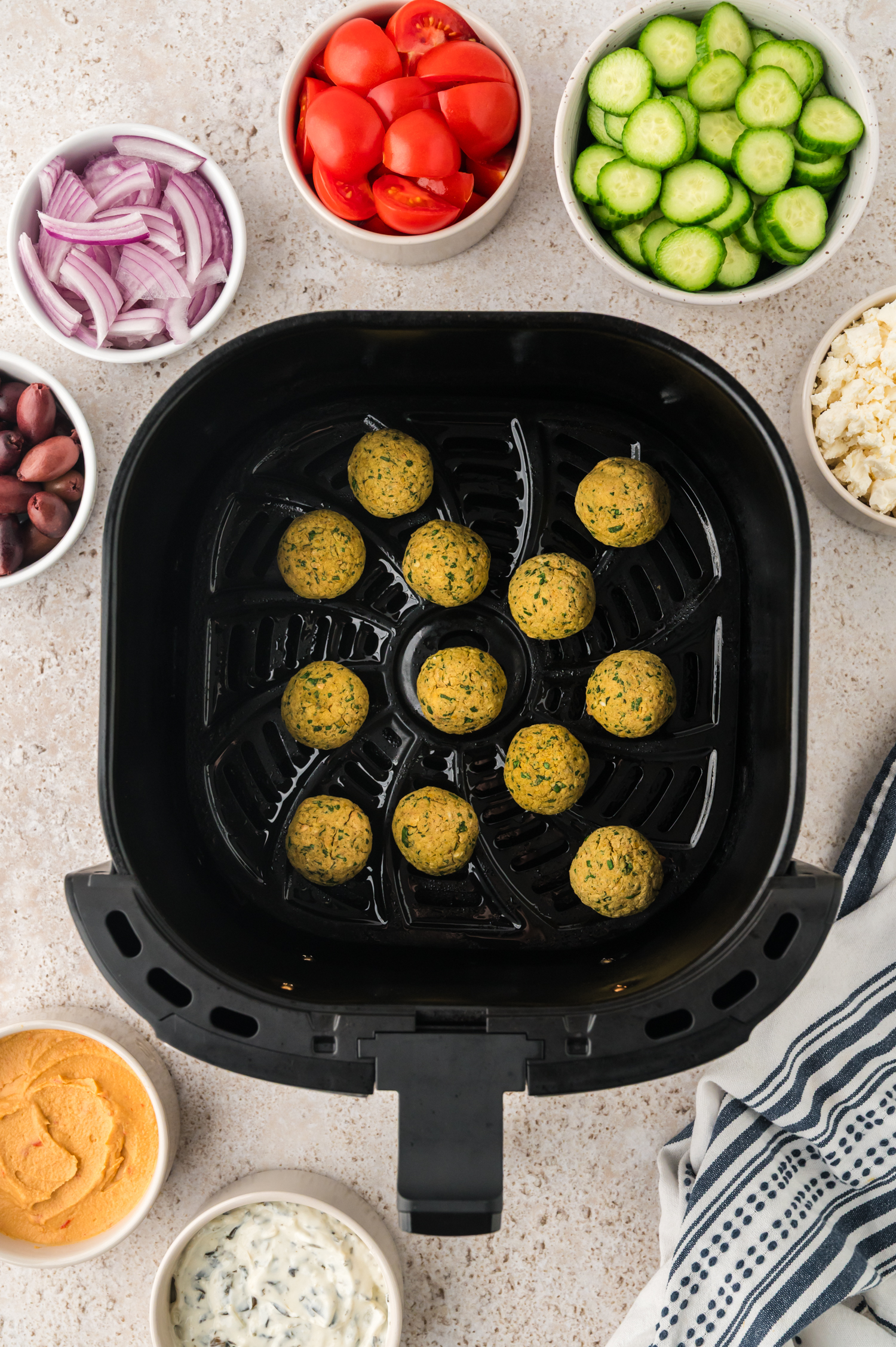 Falafel in air fryer basket.