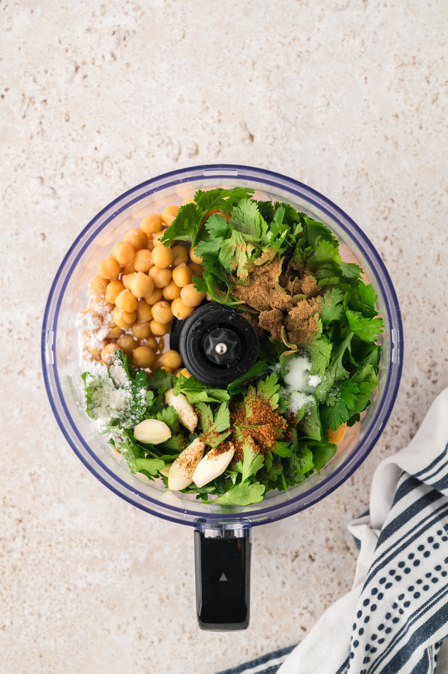 Ingredients for making falafel in food processor.