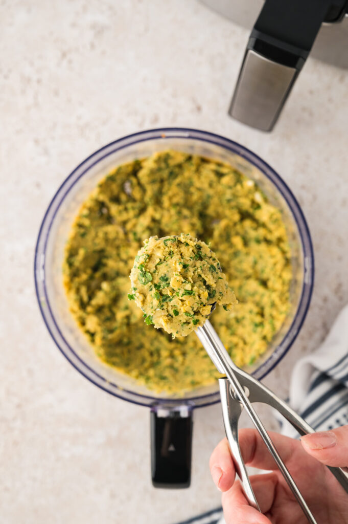 Cookie scoop filled with falafel mixture.