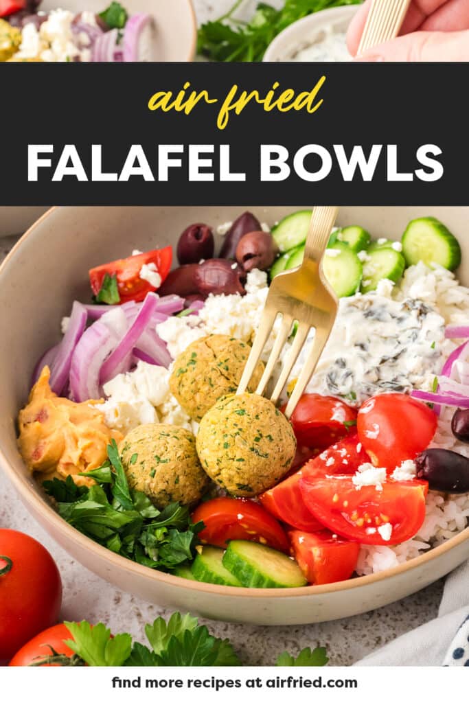 Fork grabbing a falafel in a bowl full of vegetables.