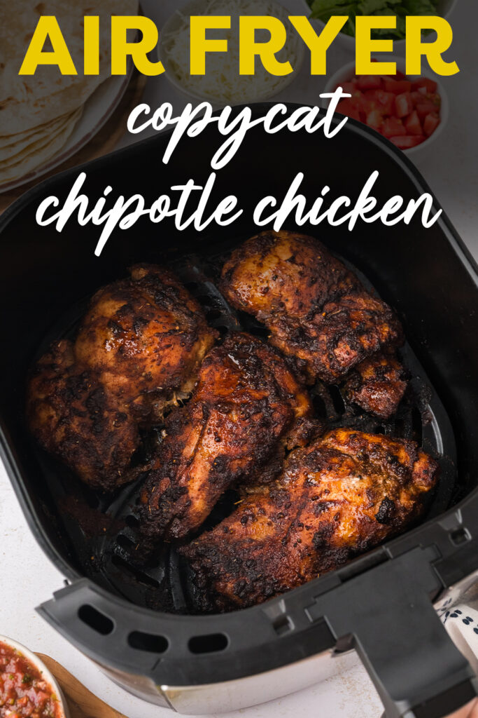 An air fryer basket with four Chipotle chicken thighs in it.