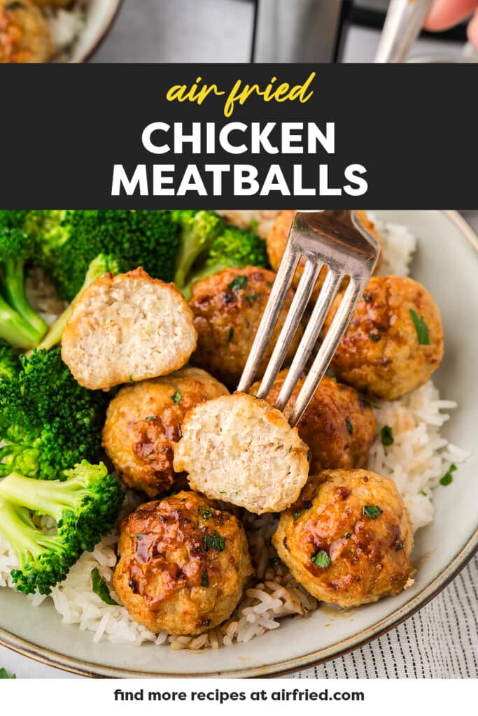 A chicken meatball cut in half on a fork.