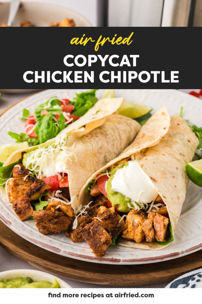 Two Chipotle chicken burritos on a plate.