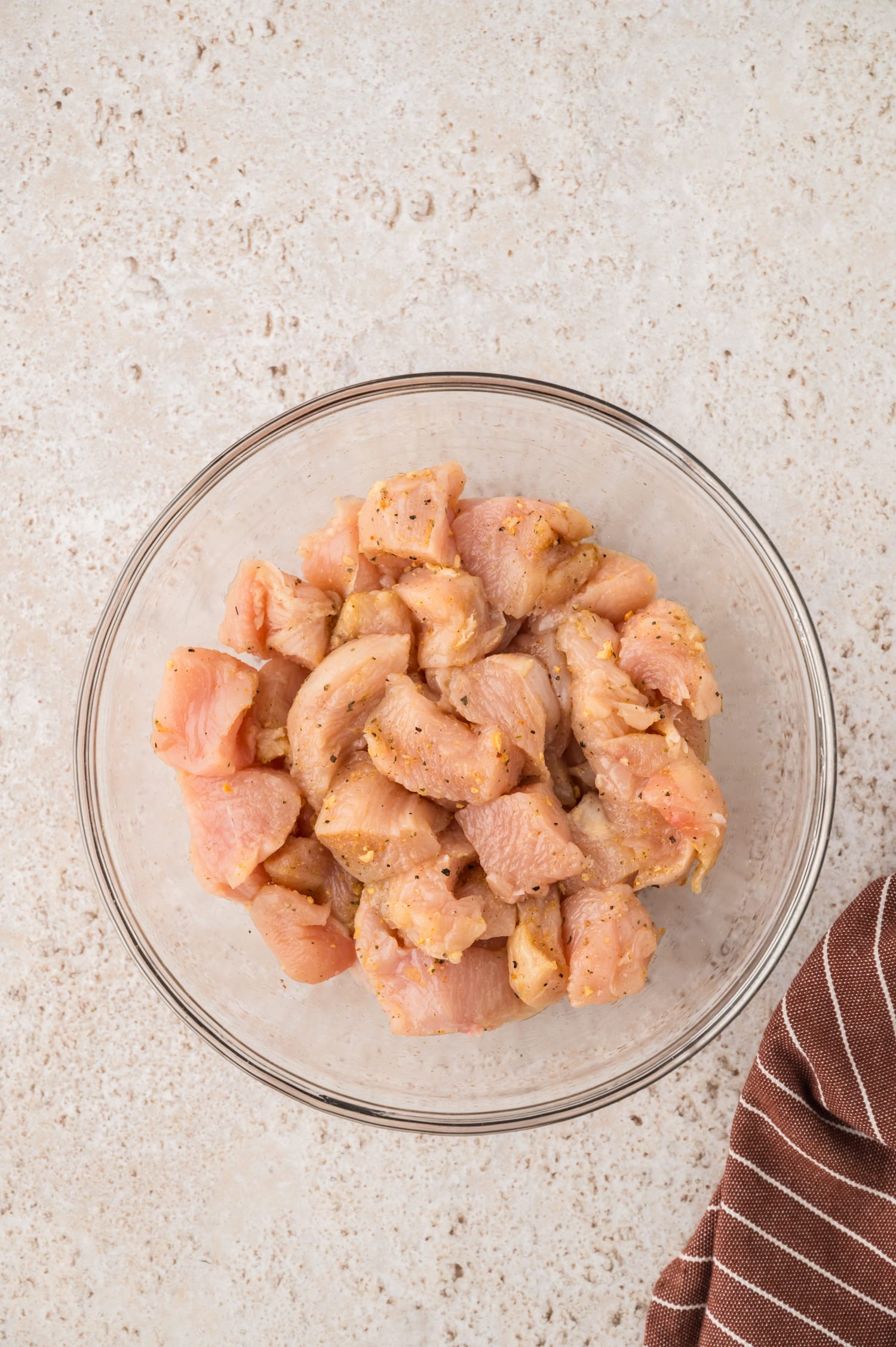 Raw cut chicken in a glass bowl,.