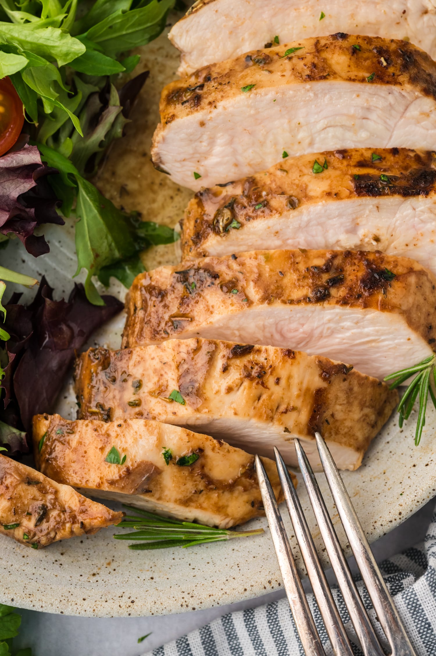 A close-up of a sliced balsamic chicken breast, showing the cooked interior and glazed exterior.