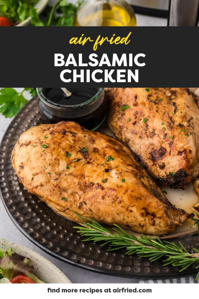 Two balsamic chicken breasts are arranged side by side on an ornate plate.