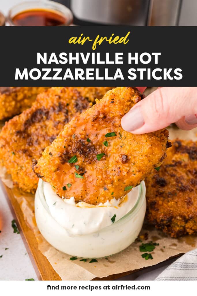 A close-up shows a person dipping a Nashville hot mozzarella stick into ranch dressing.