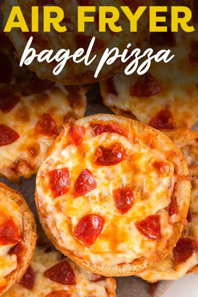 A close-up of bagel pizzas stacked on top of each other, showing the layers of toppings and melted cheese.
