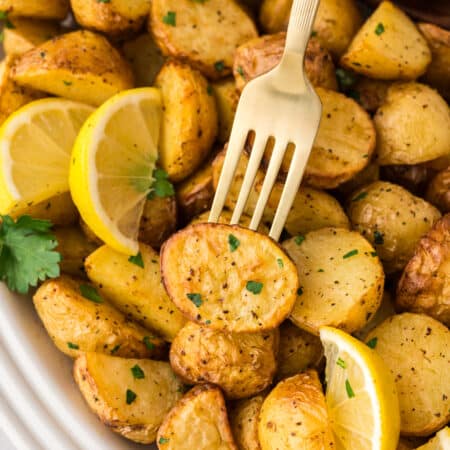 Close up of a fork stabbing into a Greek potato.