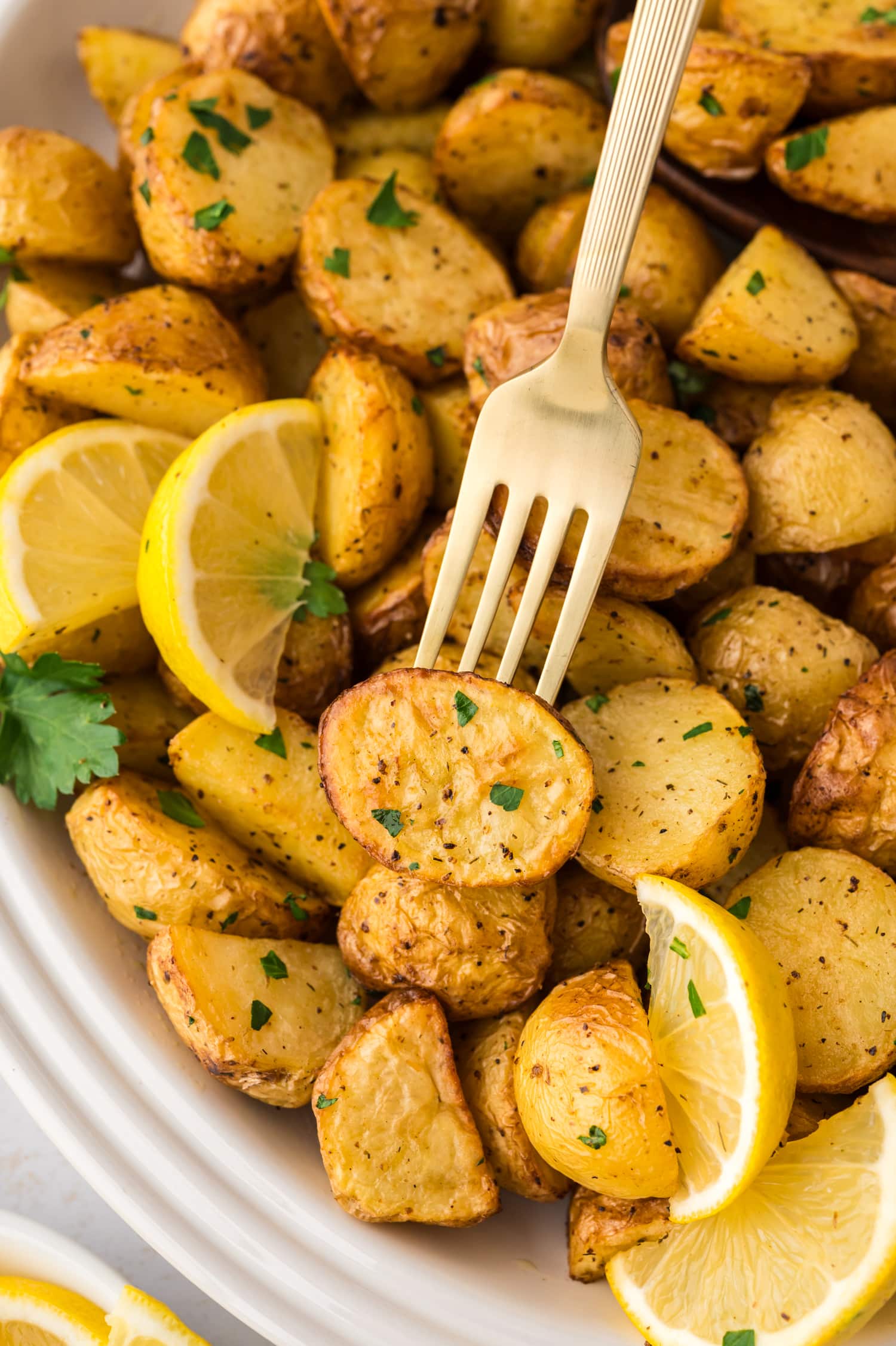 Close up of a fork stabbing into a Greek potato.