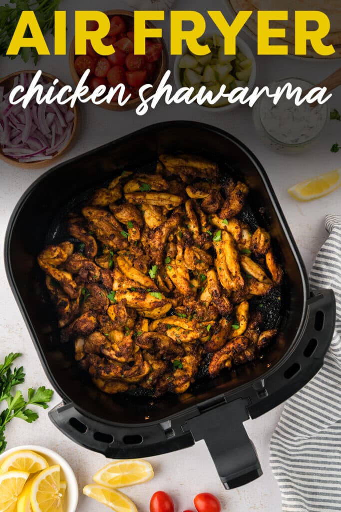 An air fryer basket full of cooked chicken shawarma.