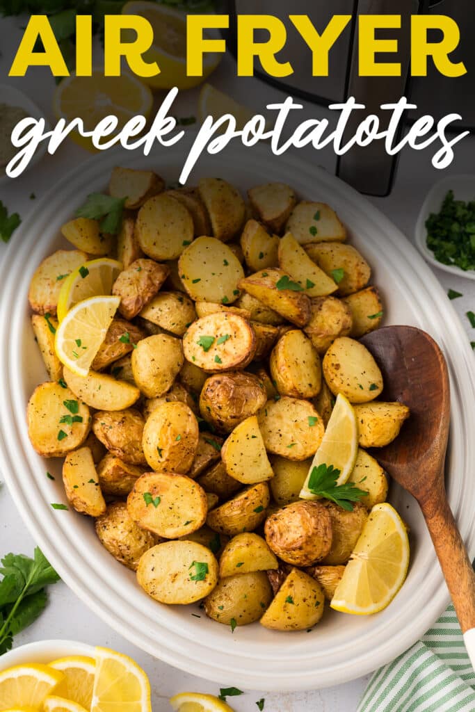A wooden spoon scooping up greek potatoes