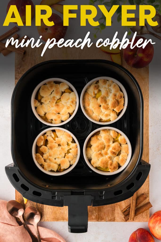 An overhead view shows four ramekins filled with cooked mini peach cobbler, arranged inside an air fryer basket.