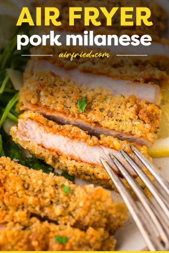 A close-up shows a piece of pork milanese that’s been sliced, revealing a tender, juicy interior with a golden, crisp coating on the outside.