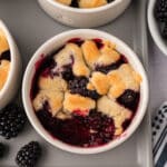 Close-up of blackberry cobbler with a bite scooped out.