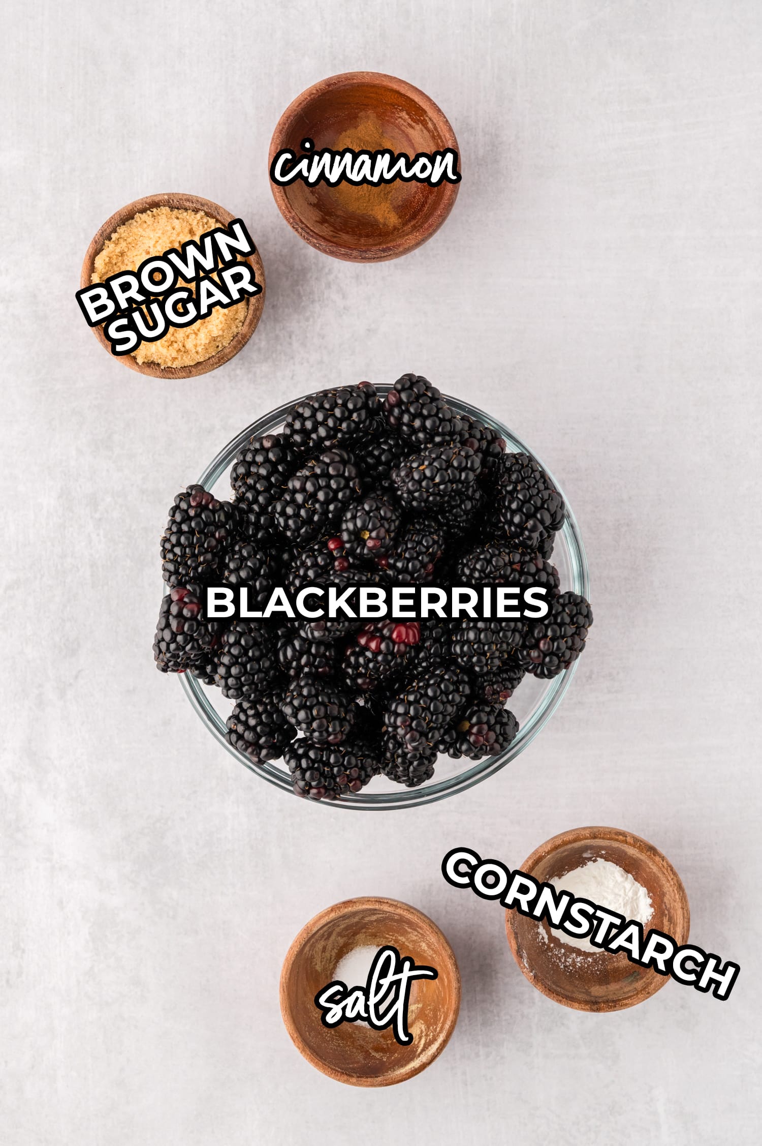 Ingredients for the cobbler filling spread out on a white countertop with labels.