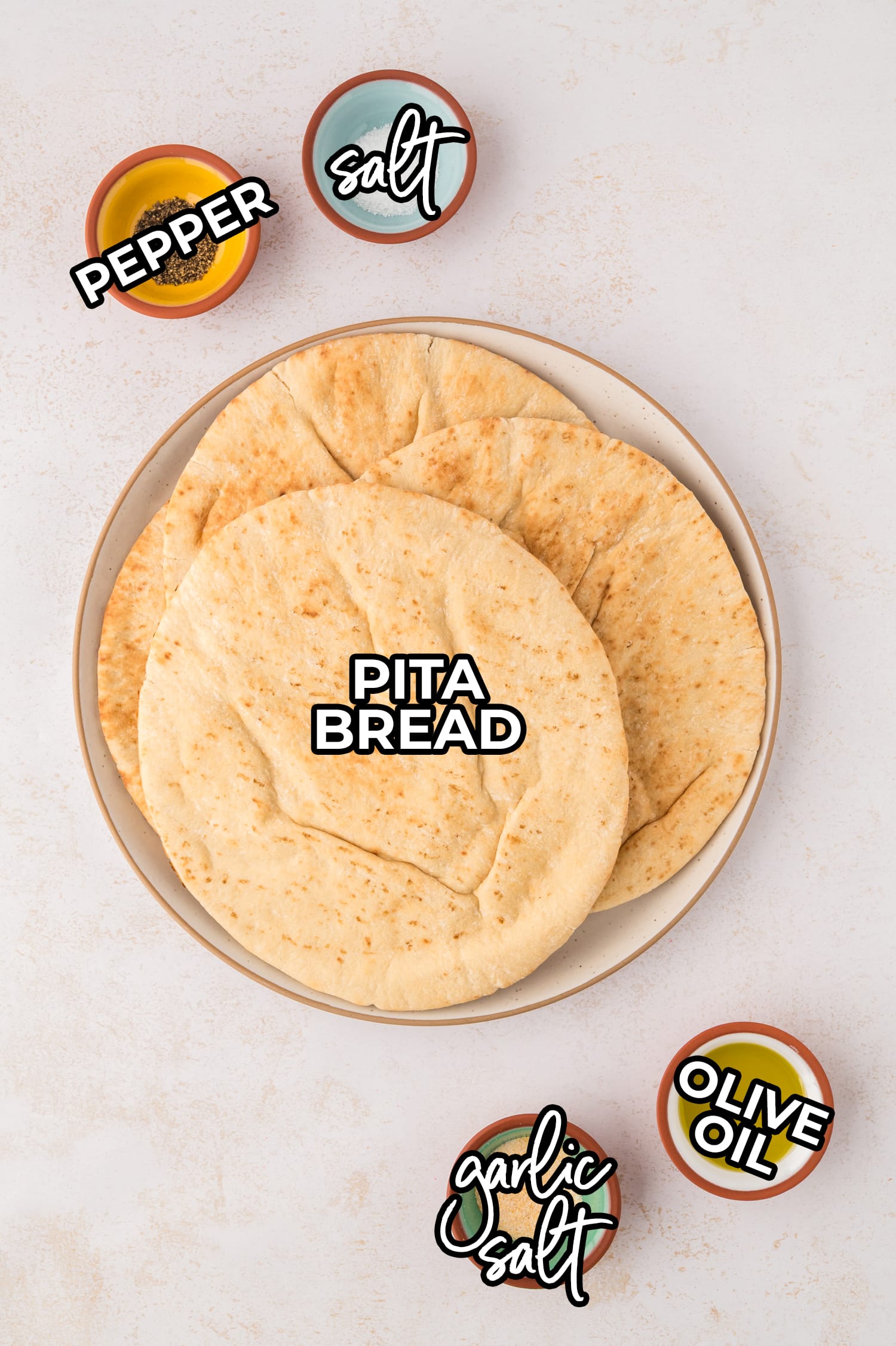 Ingredients for air fryer pita chips are arranged on a white countertop.