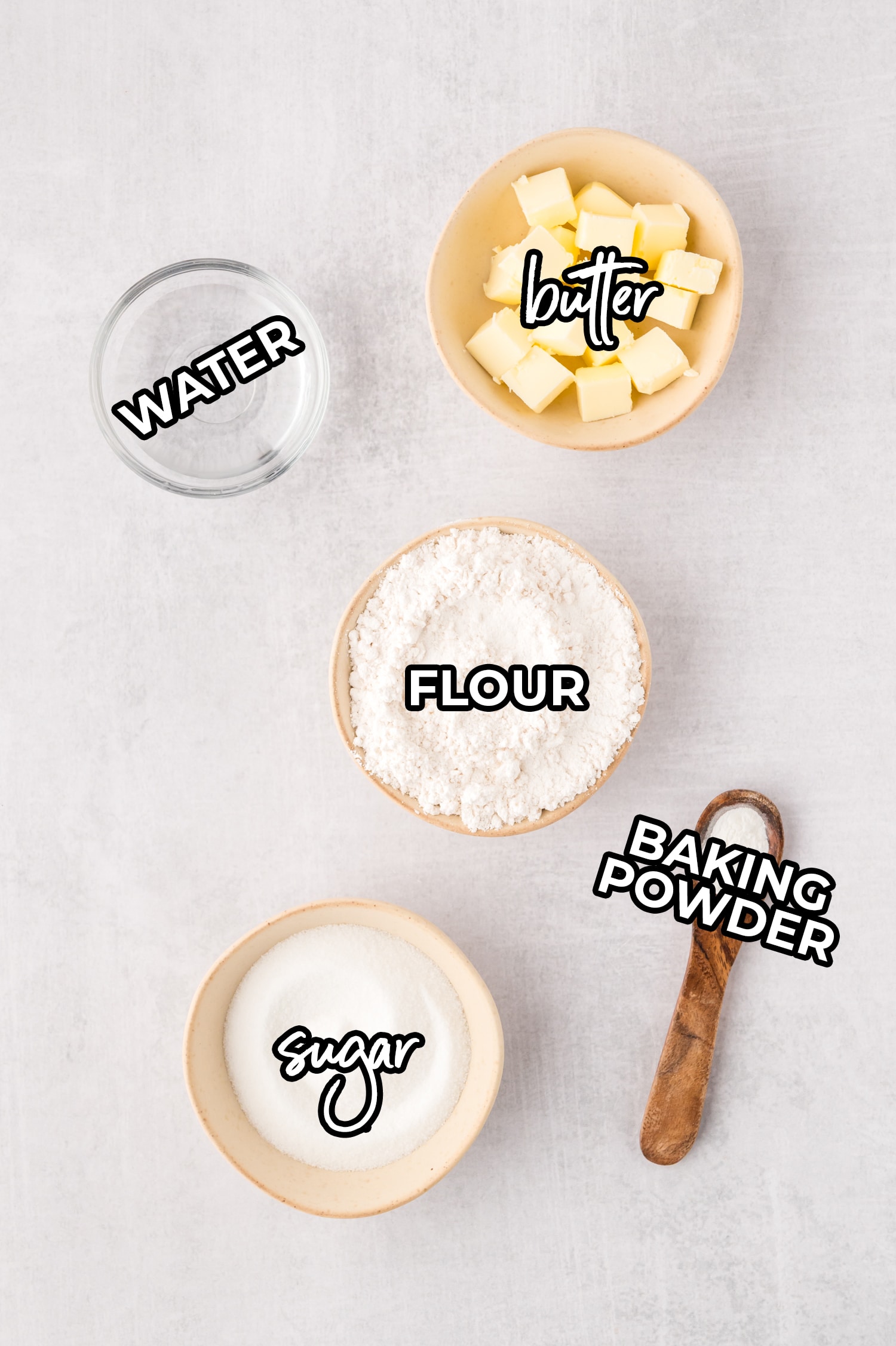 Ingredients for the cobbler crust spread out on a white countertop with labels.