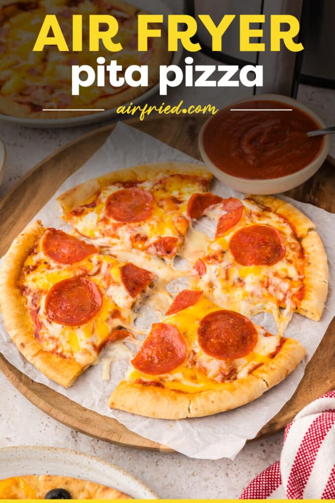 A sliced pita pizza on parchment paper.