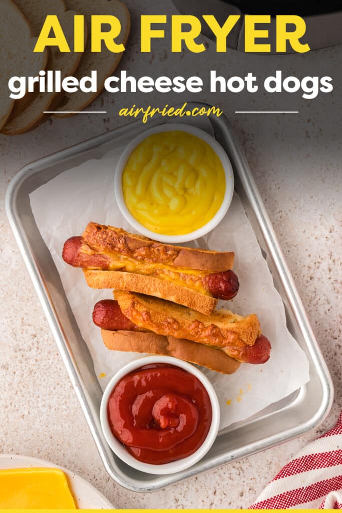 Overhead view of grilled cheese hot dogs on a tray with ketchup and mustard.