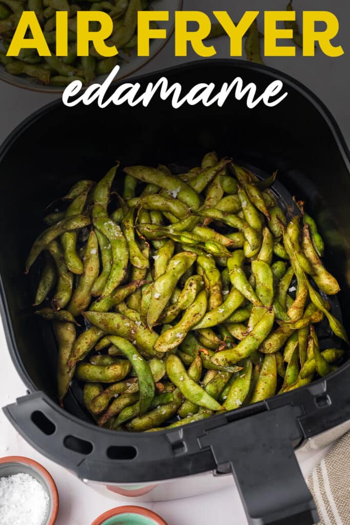 An air fryer basket full of cooked edamame.