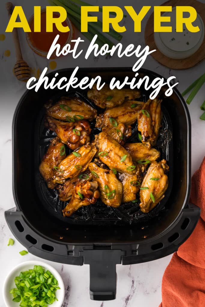 Hot honey chicken wings in air fryer basket.