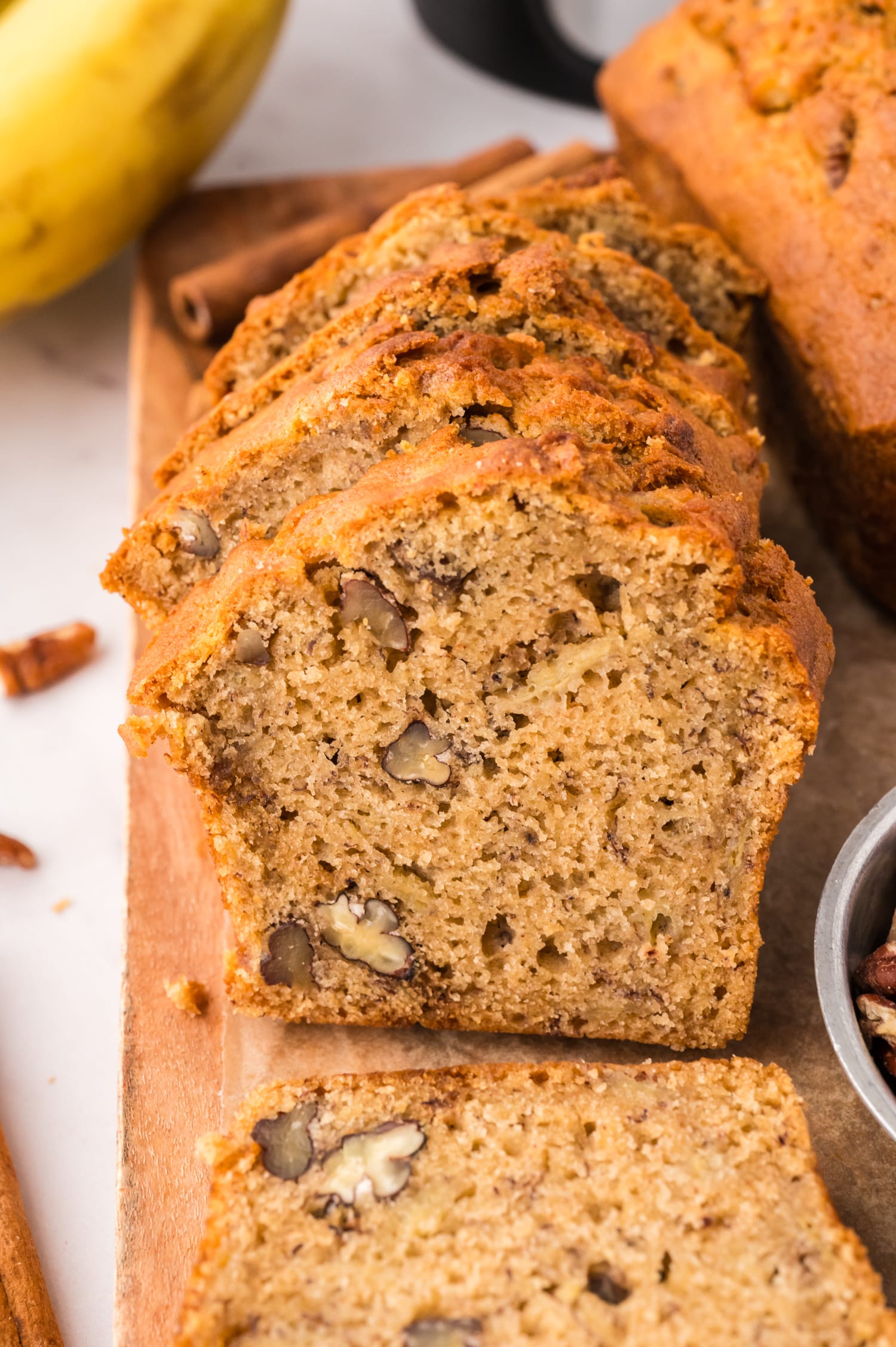 Sliced banana bread on a cutting board.