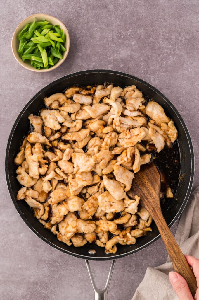 Overhead view of a skillet full of mongolian chicken.