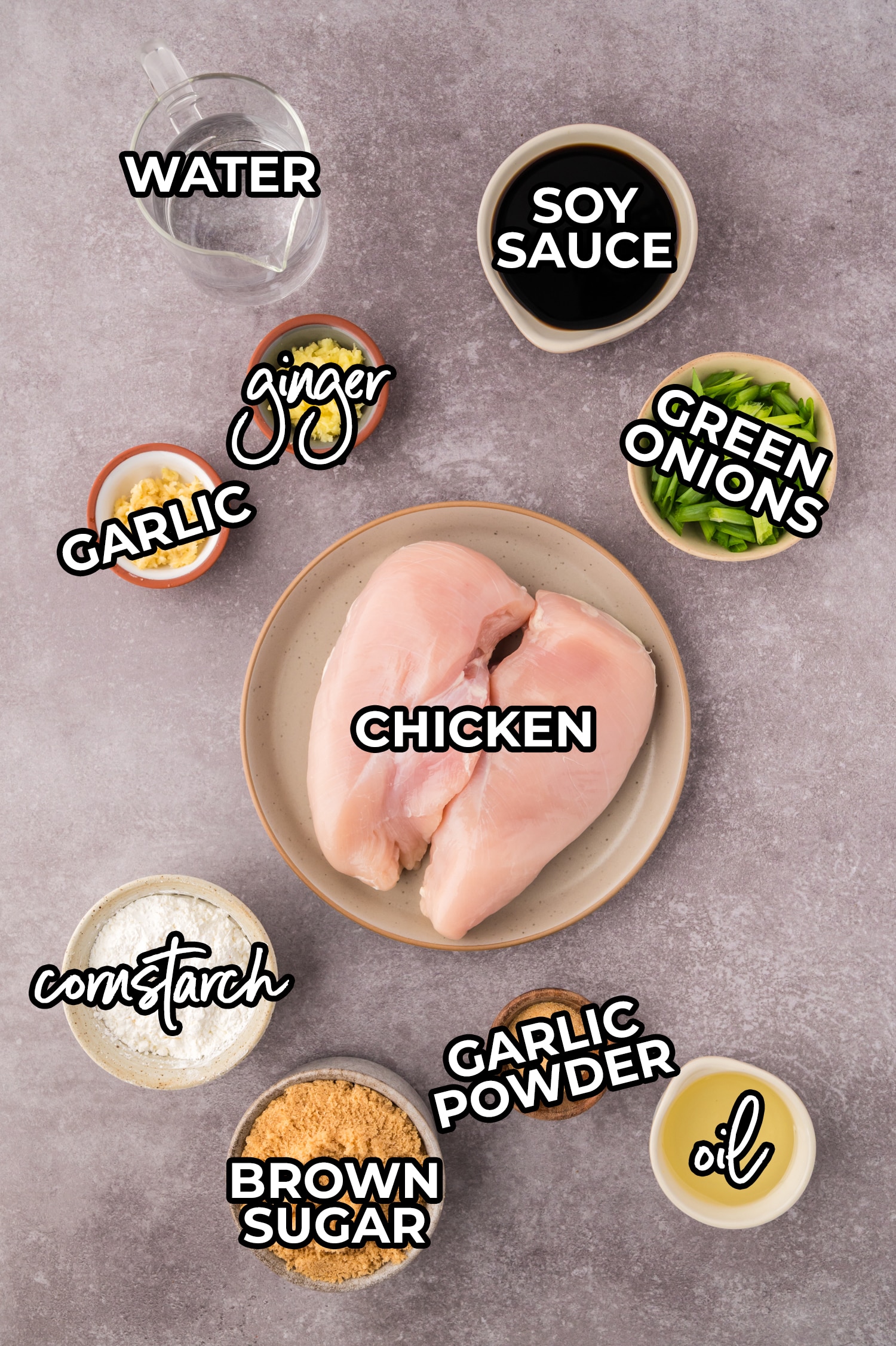 Ingredients needed for mongolian chicken spread out on a grey countertop with a text overlay.