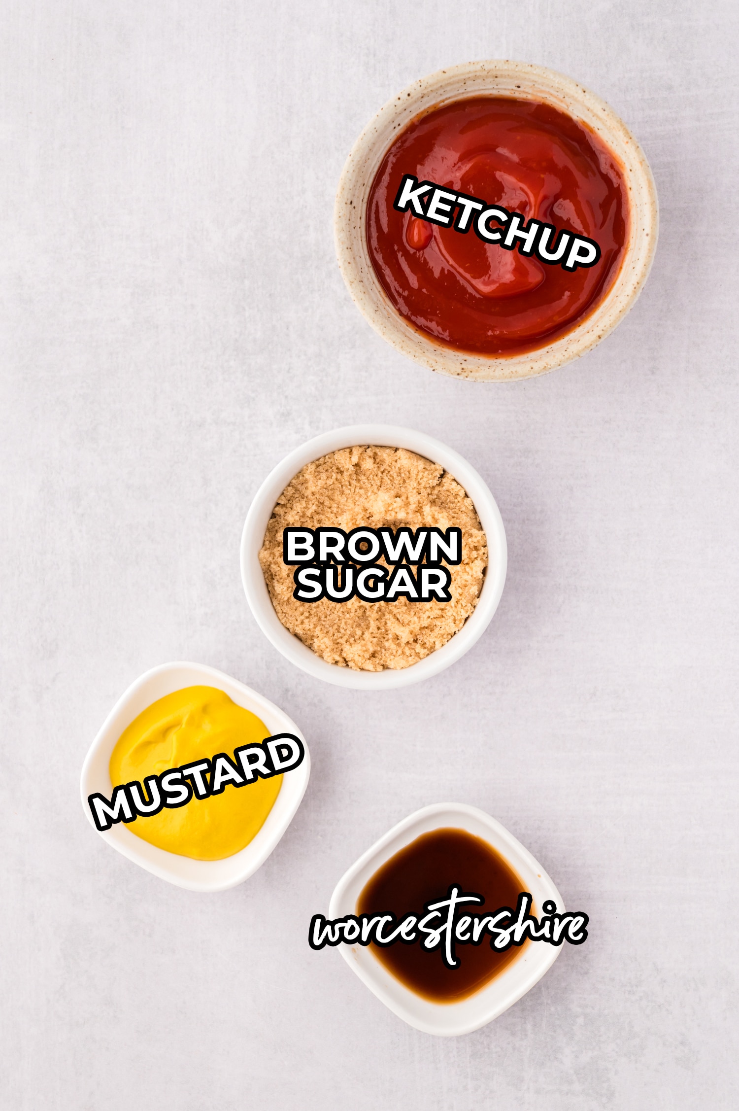 Ingredients for meatloaf sauce spread out on a white countertop with text overlay.