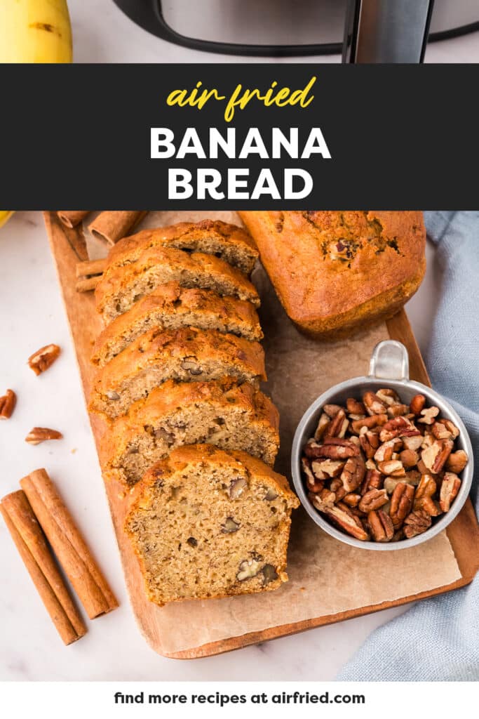 Overhead view of sliced banana bread on a wooden cutting board.