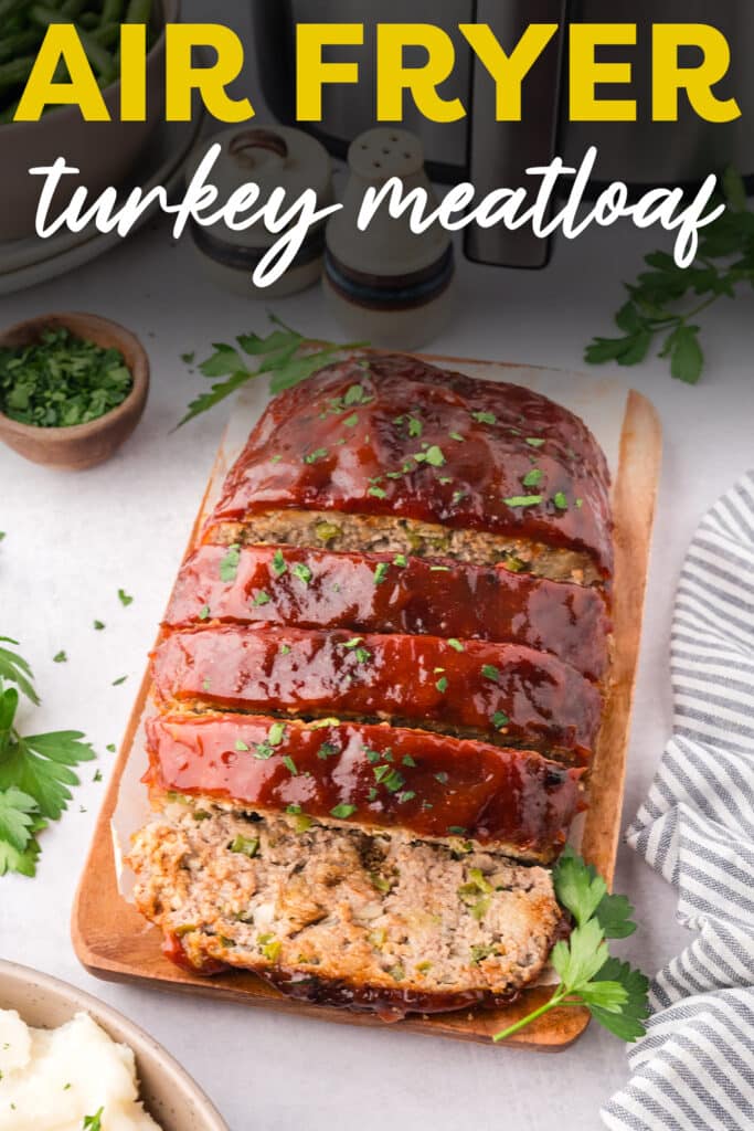 Close up of sliced turkey meatloaf on a small cutting board.