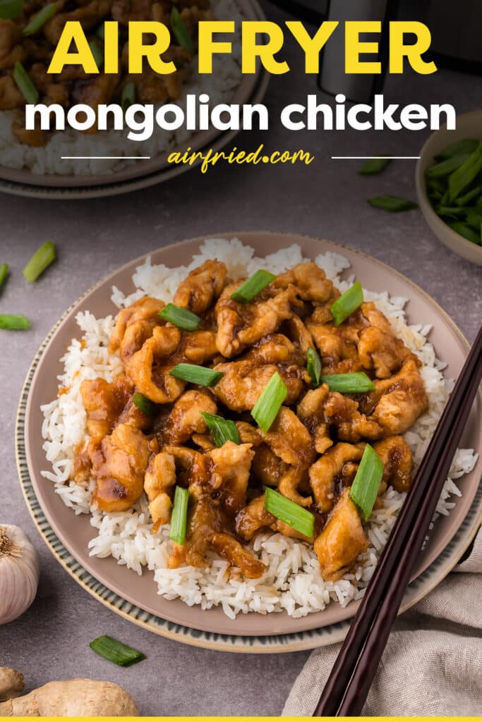 Mongolian chicken being served over rice with chopsticks.