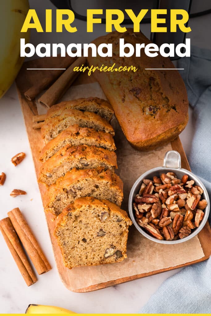 Sliced air fryer banana bread on a wooden cutting board.
