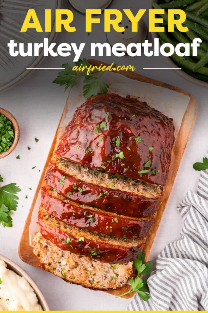Sliced turkey meatloaf on a wooden cutting board.