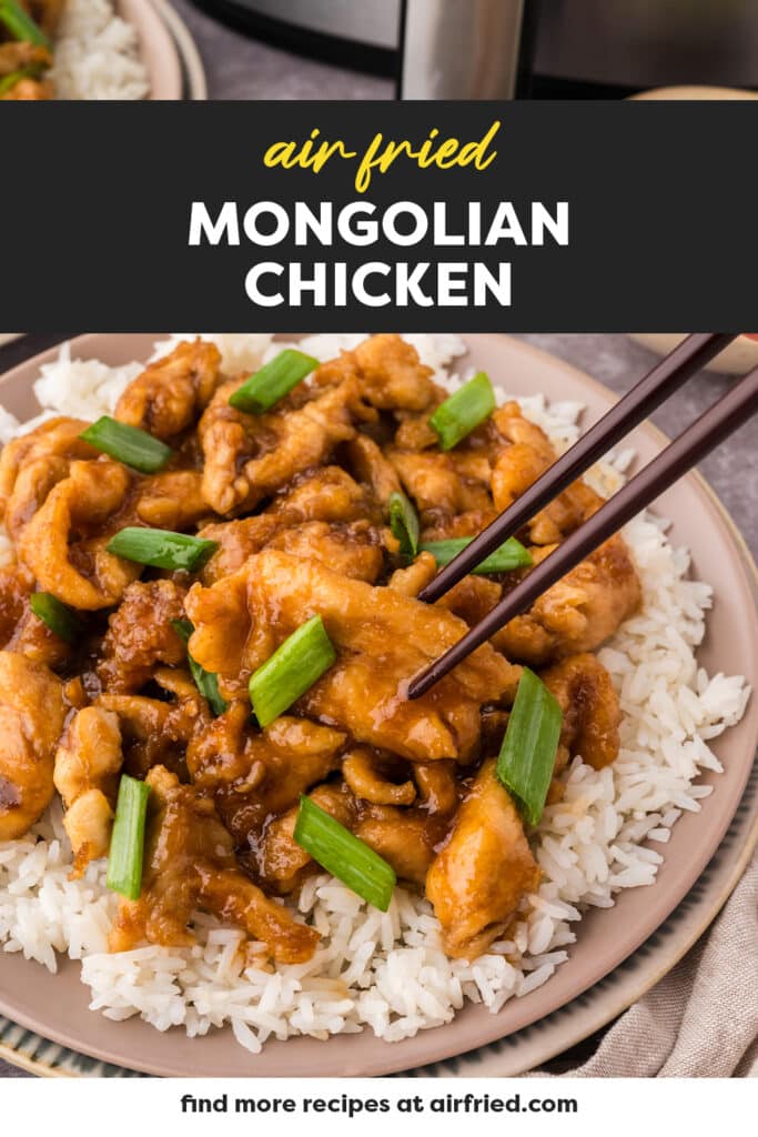 Chopsticks pulling out a piece of Mongolian chicken.