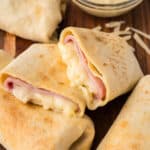 Close-up of a split air fryer ham and cheese wrap.